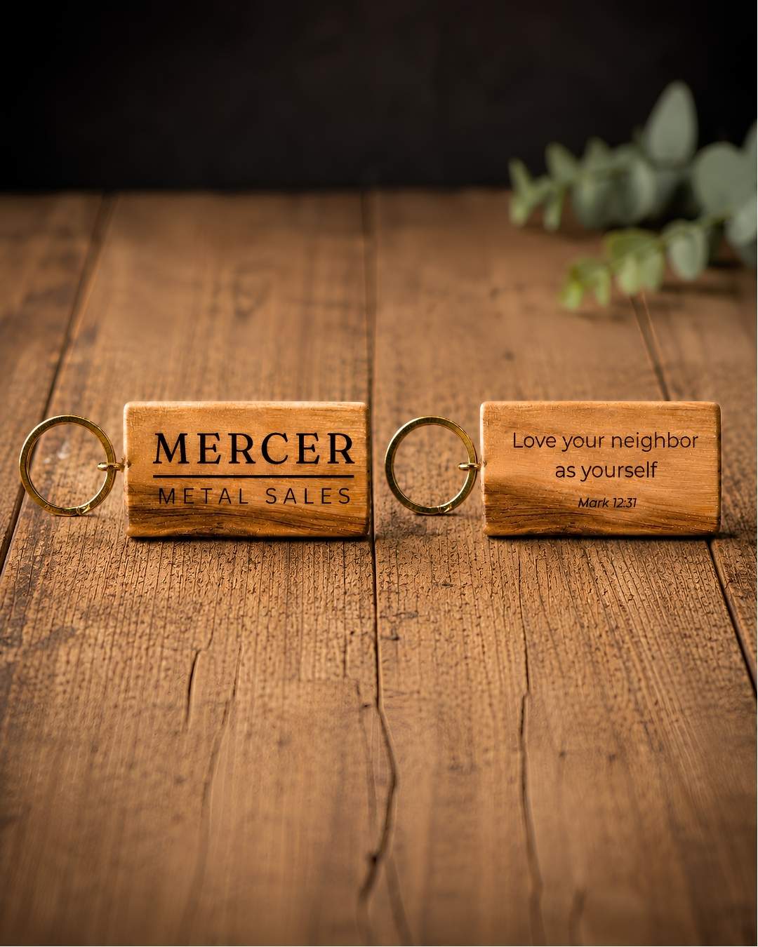 Olive wood keychains laser-engraved with a company logo, ready to send to clients