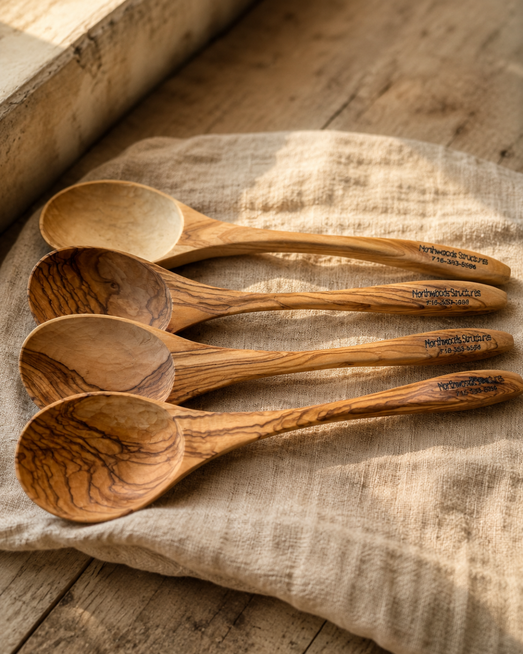 Boxed set of engraved olive wood utensils prepared as a company gift