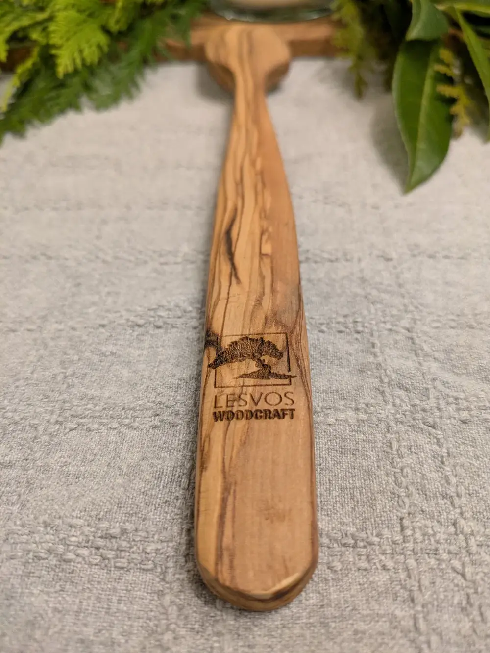 Olive wood spatula laser-engraved with the Lesvos Woodcraft logo