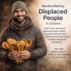 Portrait of a smiling artisan in Greece holding hand-carved olive wood cooking utensils, representing Lesvos Woodcraft’s mission of employing displaced people to create handcrafted kitchenware and support ethical, purpose-driven craftsmanship.